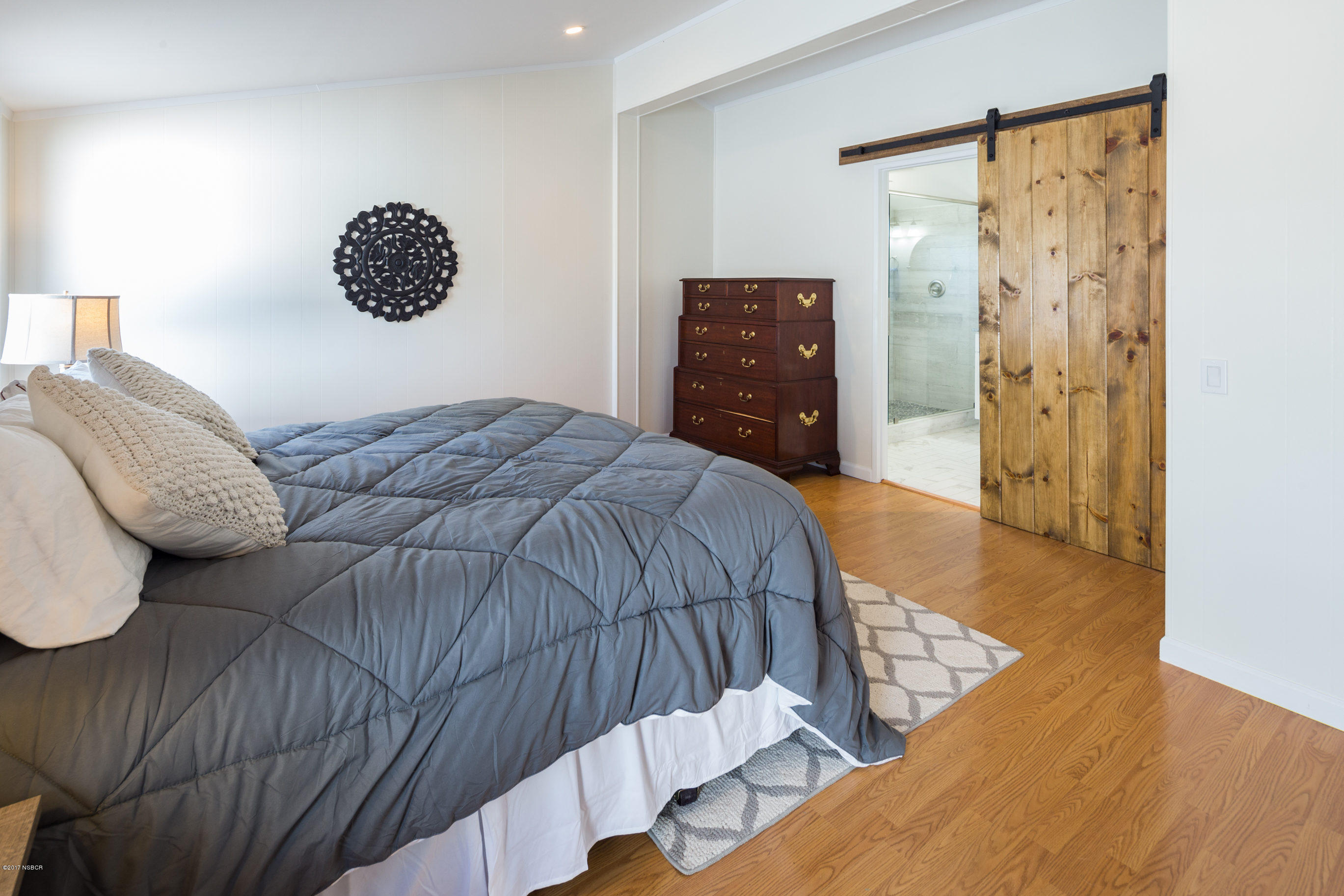 2075 North Refugio Road Santa Ynez, CA 93460 - Photo 20 of 46 a bedroom with a bed and painting on the wall