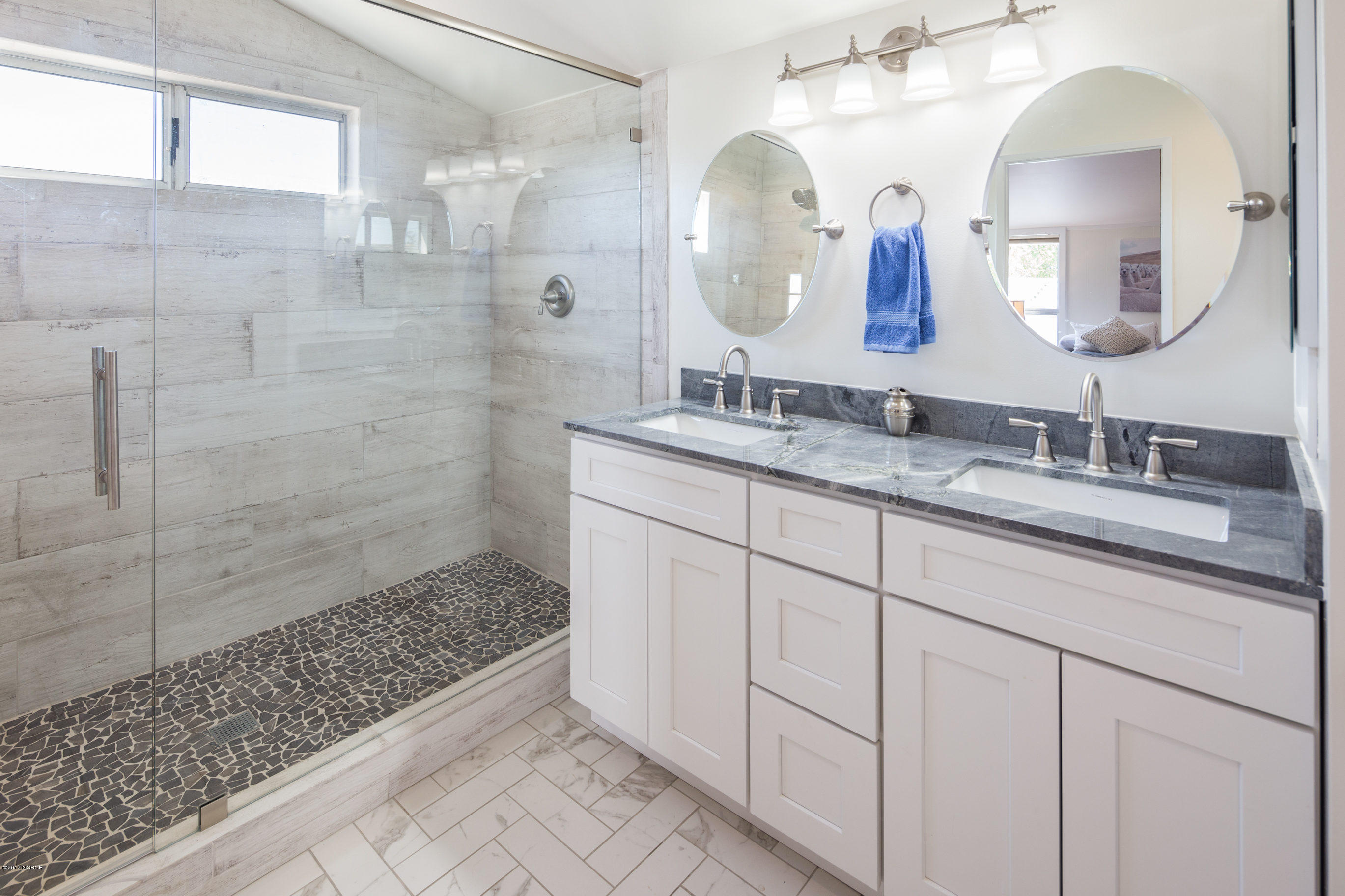 2075 North Refugio Road Santa Ynez, CA 93460 - Photo 22 of 46 a bathroom with a double vanity sink mirror and shower