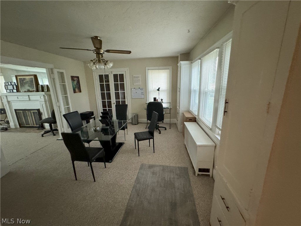 317 Center Road Bedford, OH 44146 - Photo 11 of 16 Carpeted living room featuring ceiling fan and radiator heating unit