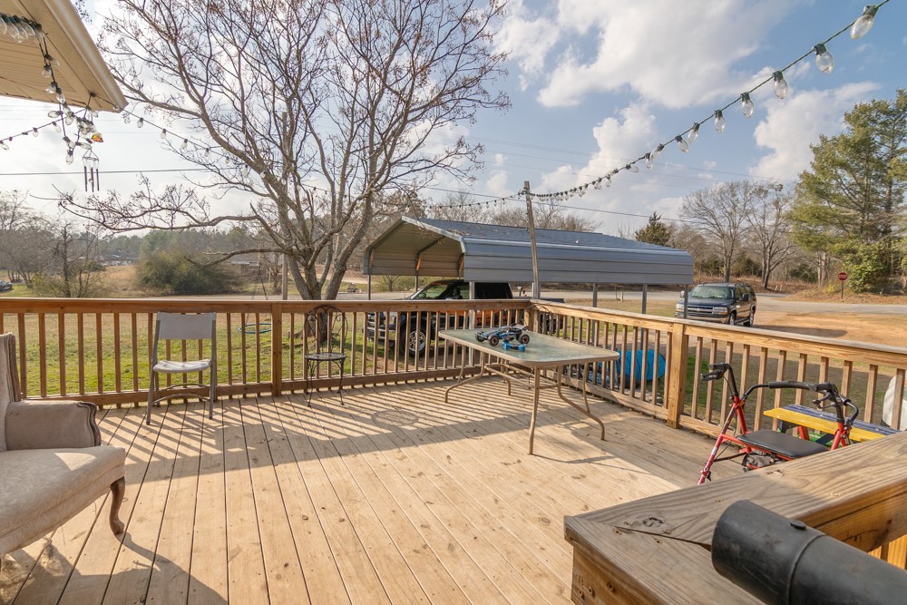 708 Sexton Gin Road Iva, SC 29655 - Photo 6 of 20 This spacious wooden deck offers an inviting outdoor retreat with scenic views.