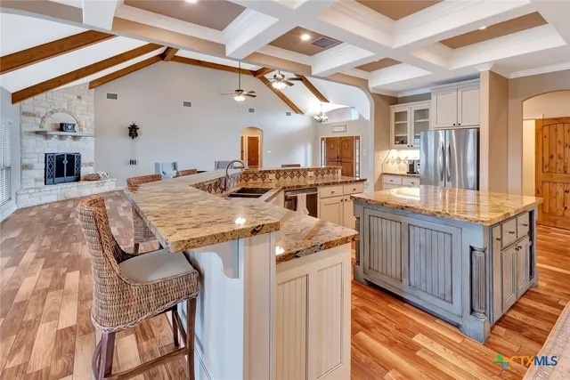 a bathroom with a granite countertop sink a mirror a bathtub and shower