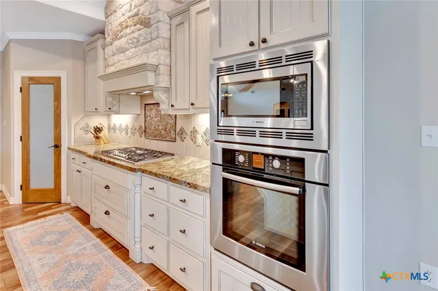 a en suite bathroom with a granite countertop sink and a mirror