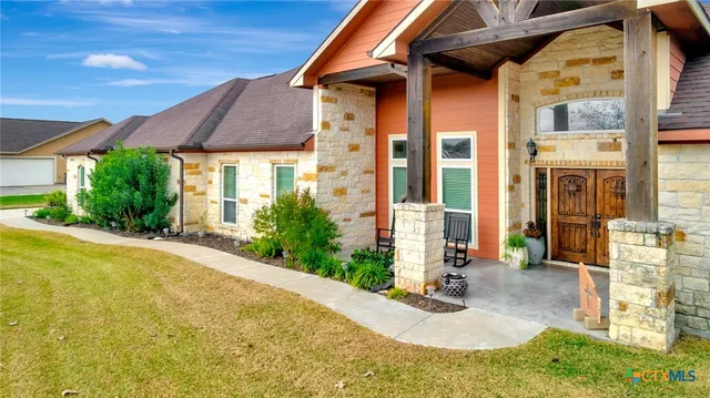 a kitchen with granite countertop a sink and cabinets