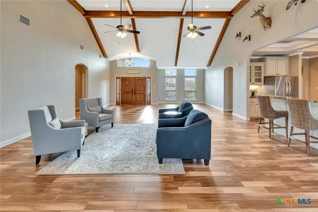 a spacious bedroom with a bed and a chandelier