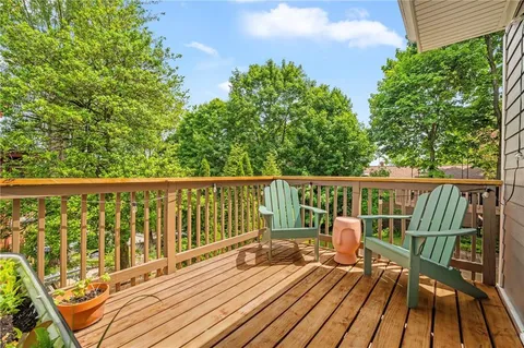 a view of a wooden deck with chairs