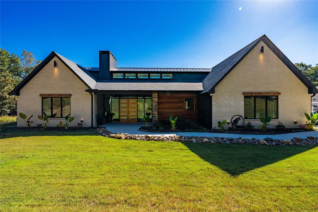 a view of a house with swimming pool and a yard