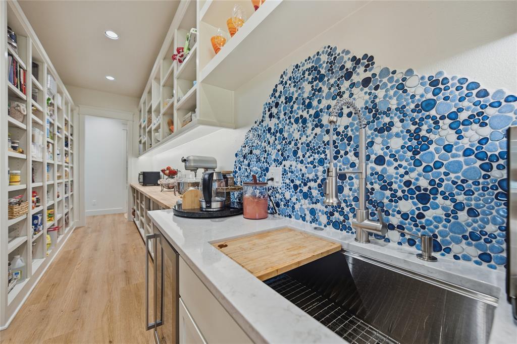 8701 Zebra Crossing Larue, TX 75770 - Photo 21 of 38 a kitchen with stainless steel appliances kitchen island a stove a chimney a sink and cabinets