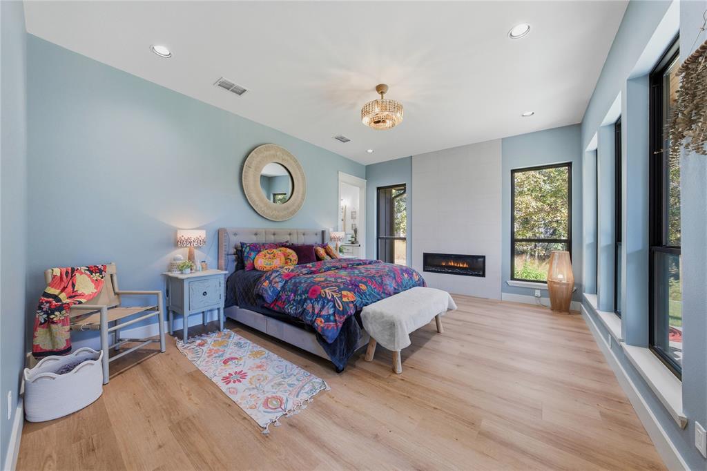 8701 Zebra Crossing Larue, TX 75770 - Photo 22 of 38 a bedroom with a bed and a chandelier