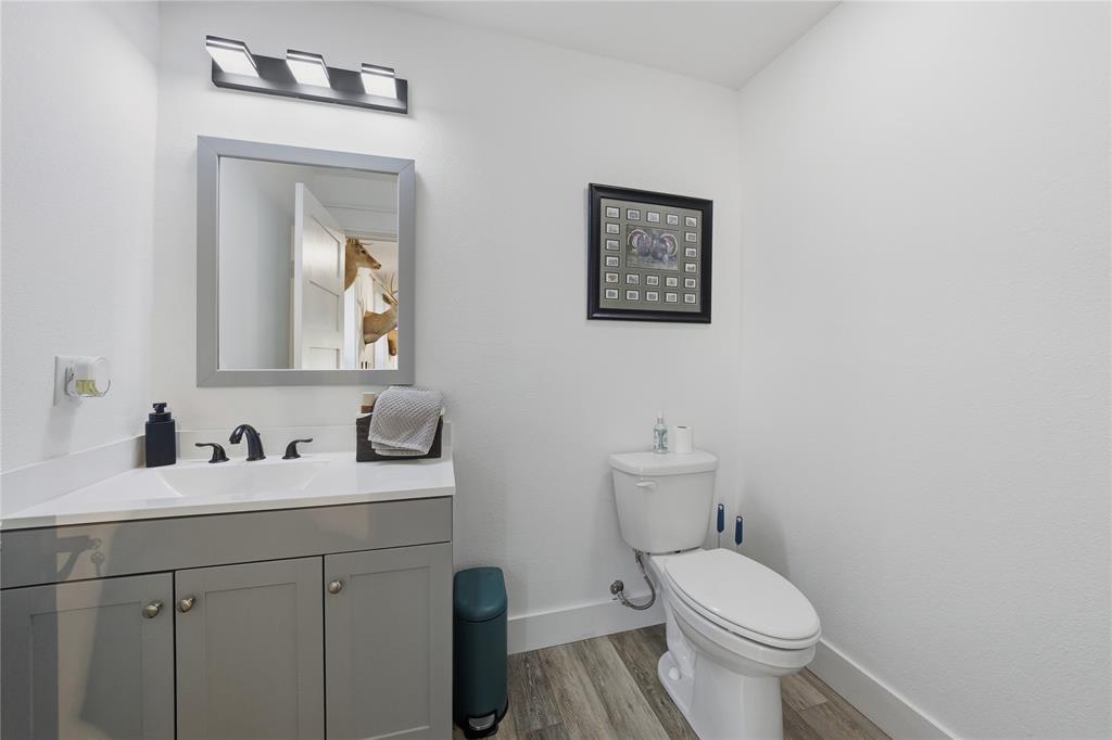 8701 Zebra Crossing Larue, TX 75770 - Photo 25 of 38 a bathroom with a toilet sink and mirror