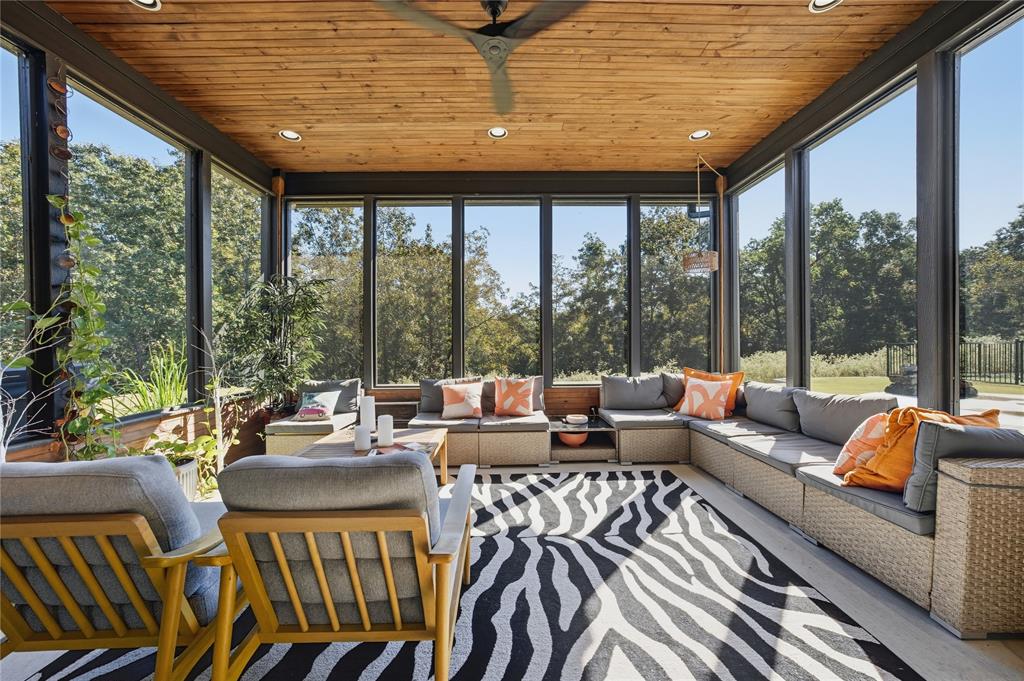 8701 Zebra Crossing Larue, TX 75770 - Photo 27 of 38 a living room with furniture and floor to ceiling windows
