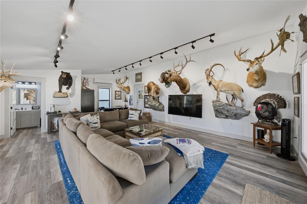 8701 Zebra Crossing Larue, TX 75770 - Photo 29 of 38 a living room with furniture and a wooden floor