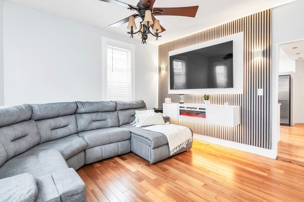 42 D Street Lowell, MA 01851 - Photo 10 of 27 a living room with furniture and a flat screen tv