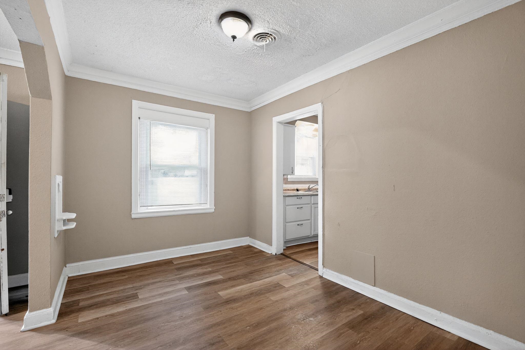 356 Hewlett Road Memphis, TN 38109 - Photo 13 of 30 Unfurnished bedroom with ornamental molding, light wood-style floors, and a textured ceiling