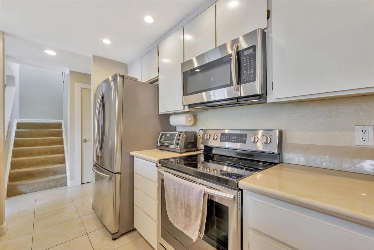3415 La Selva Street San Mateo, CA 94403 - Photo 11 of 33 a kitchen with stainless steel appliances granite countertop a stove a refrigerator and a microwave