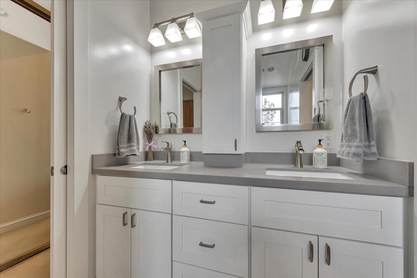3415 La Selva Street San Mateo, CA 94403 - Photo 18 of 33 a bathroom with a granite countertop sink vanity and mirror