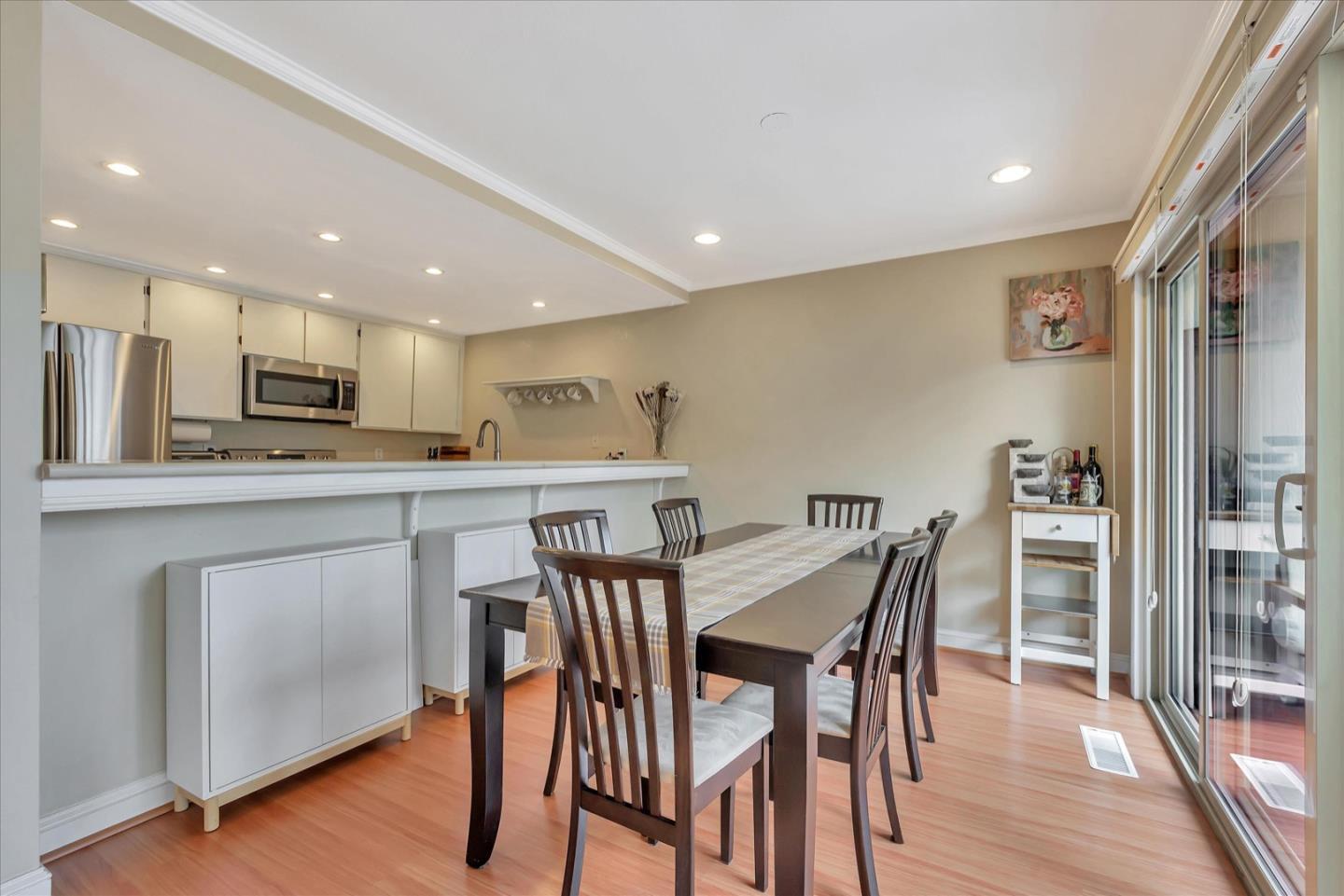 3415 La Selva Street San Mateo, CA 94403 - Photo 9 of 33 a kitchen with stainless steel appliances kitchen island granite countertop a dining table chairs and granite counter tops