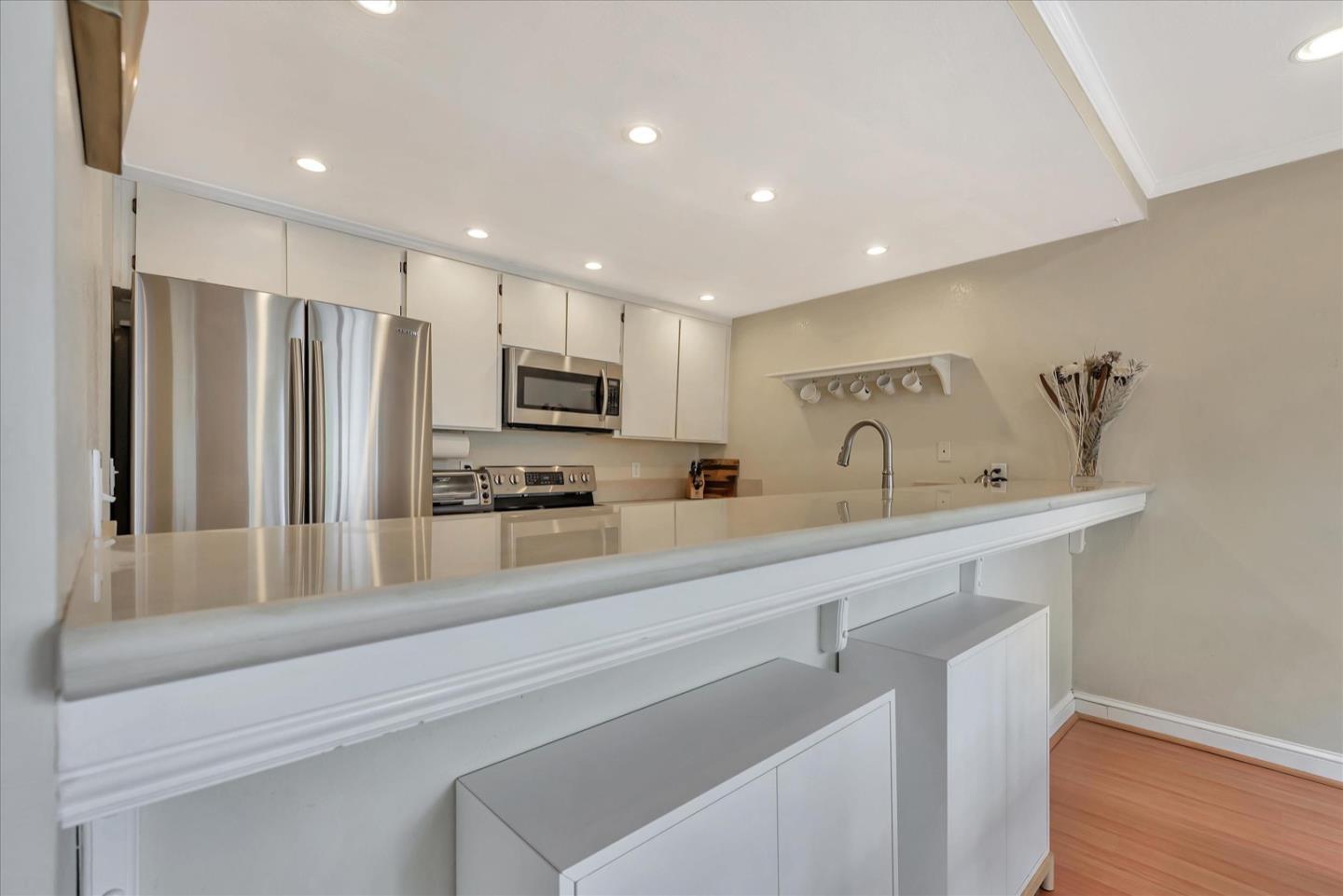 3415 La Selva Street San Mateo, CA 94403 - Photo 10 of 33 a kitchen with stainless steel appliances a sink cabinets and wooden floor