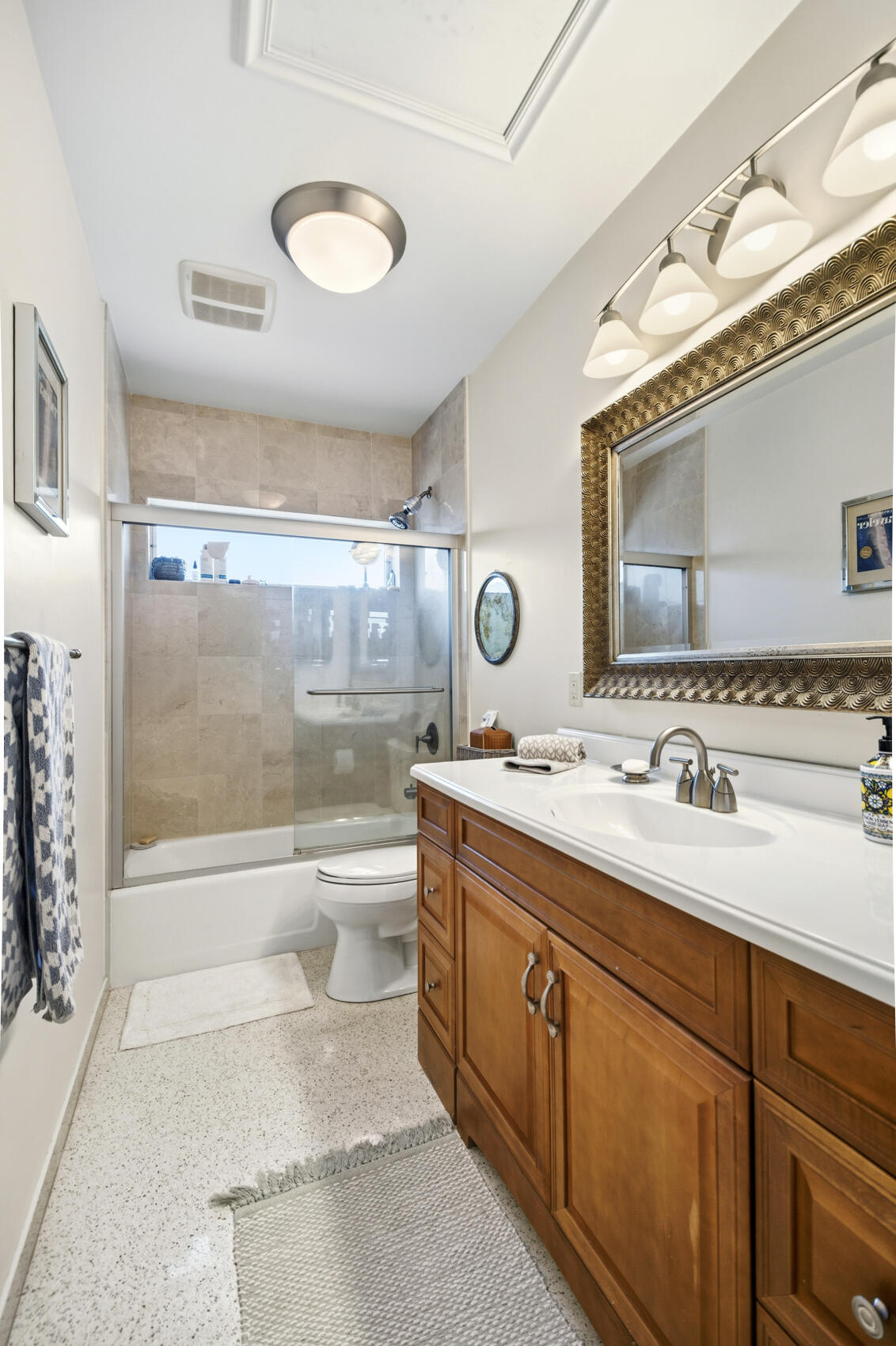 1348 Southwest 4th Street Boca Raton, FL 33486 - Photo 22 of 44 a bathroom with a granite countertop sink toilet a mirror and bathtub