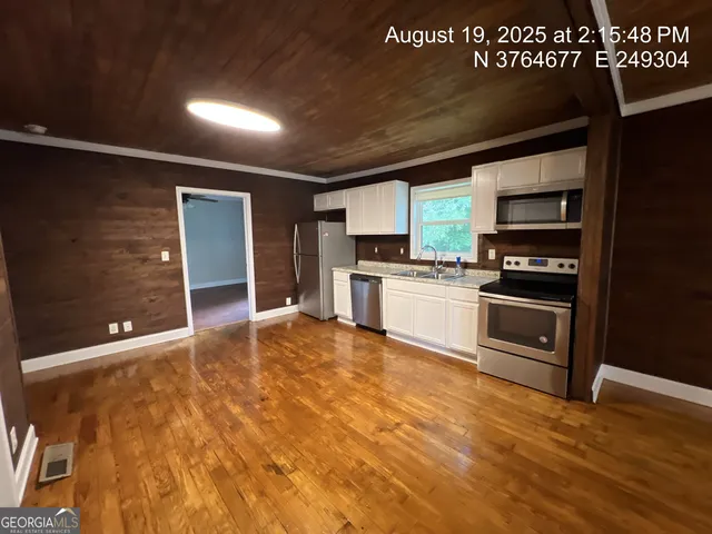 a kitchen with stainless steel appliances granite countertop a stove a sink and a refrigerator