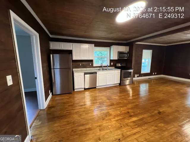 a view of a kitchen with a sink cabinets and a refrigerator