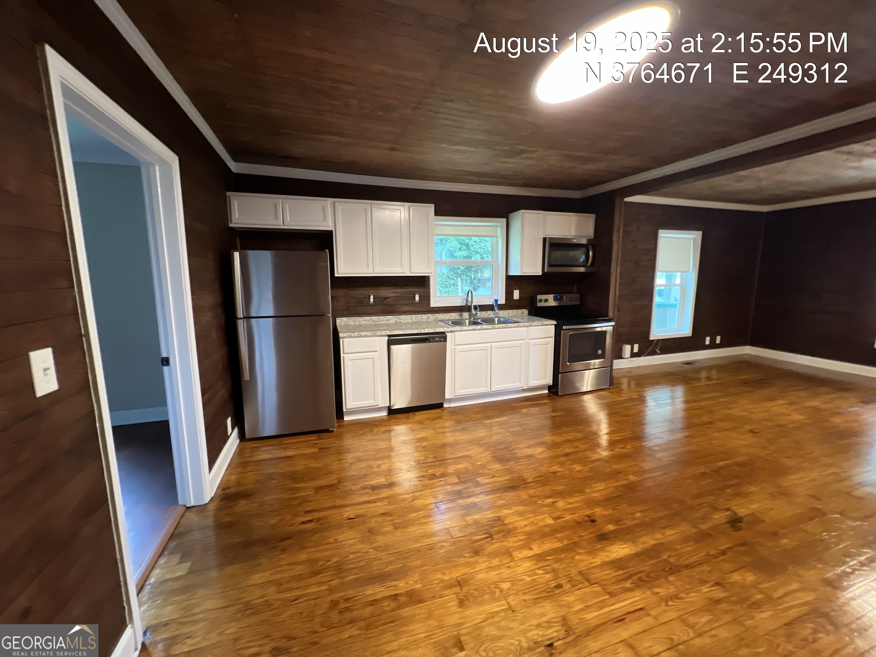 186 Georgia Avenue, Unit B Winder, GA 30680 - Photo 7 of 24 a view of a kitchen with a sink cabinets and a refrigerator