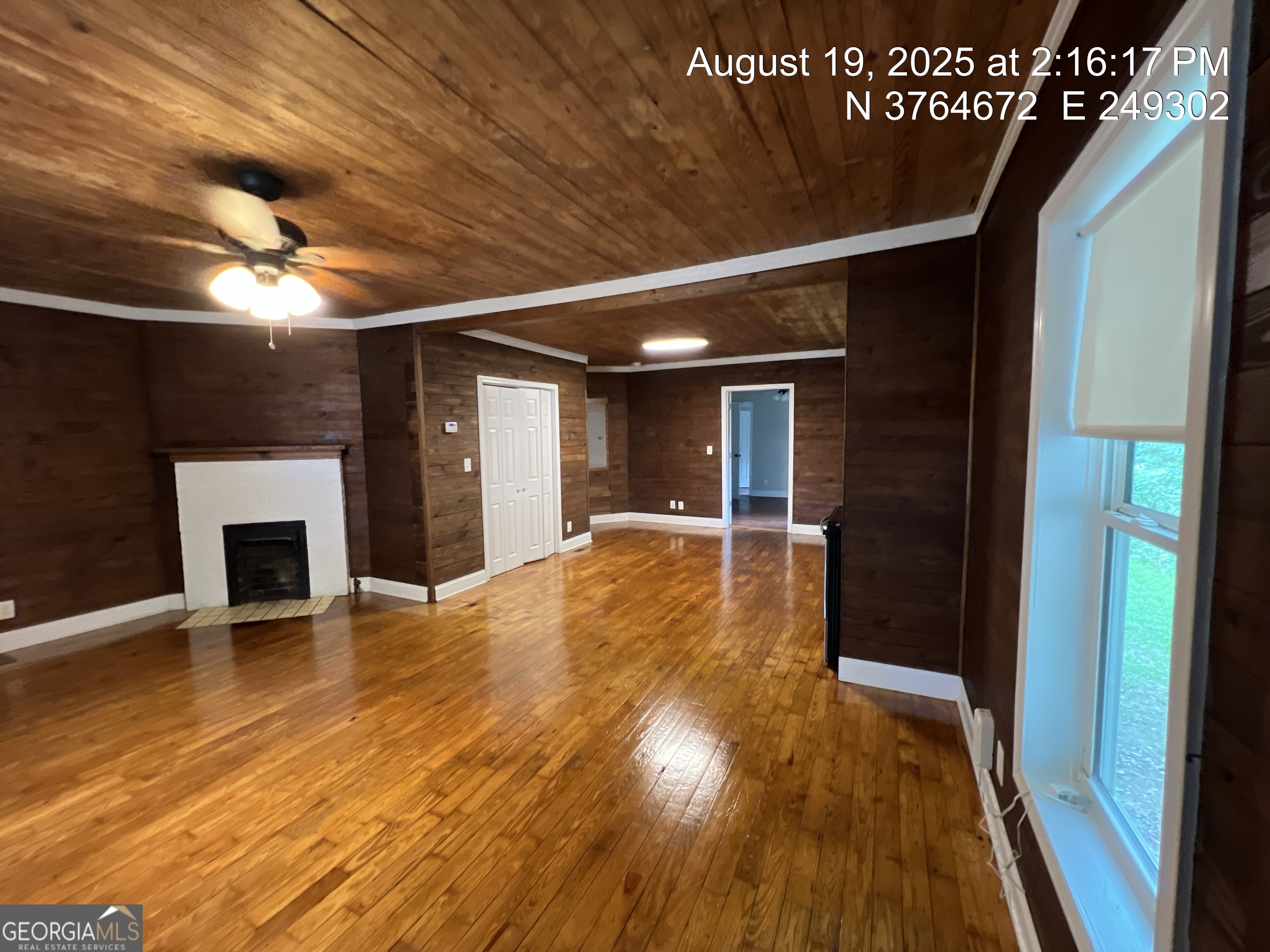 186 Georgia Avenue, Unit B Winder, GA 30680 - Photo 8 of 24 a view of an empty room with wooden floor a fireplace