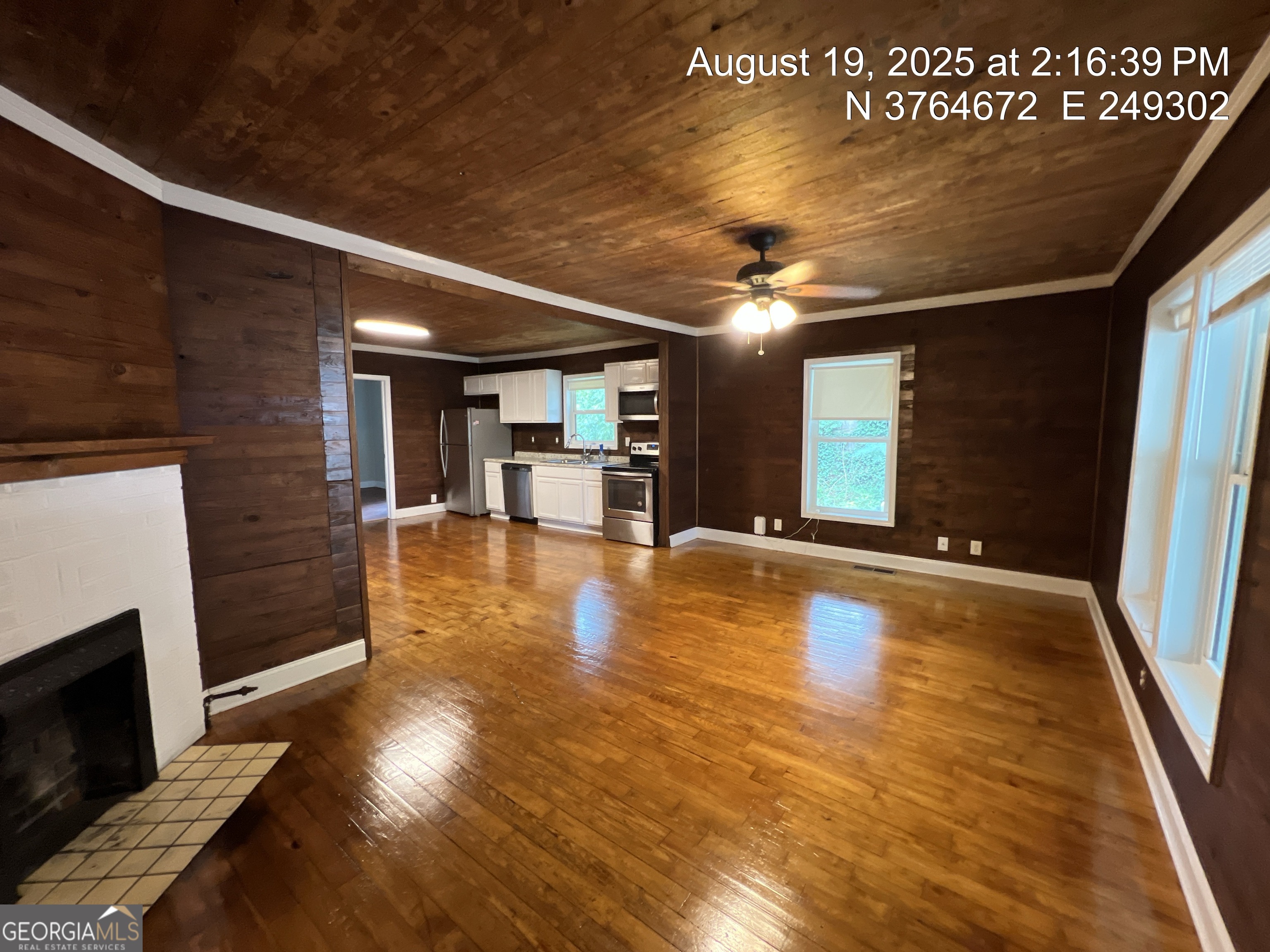 186 Georgia Avenue, Unit B Winder, GA 30680 - Photo 9 of 24 a view of an empty room with wooden floor and a fireplace