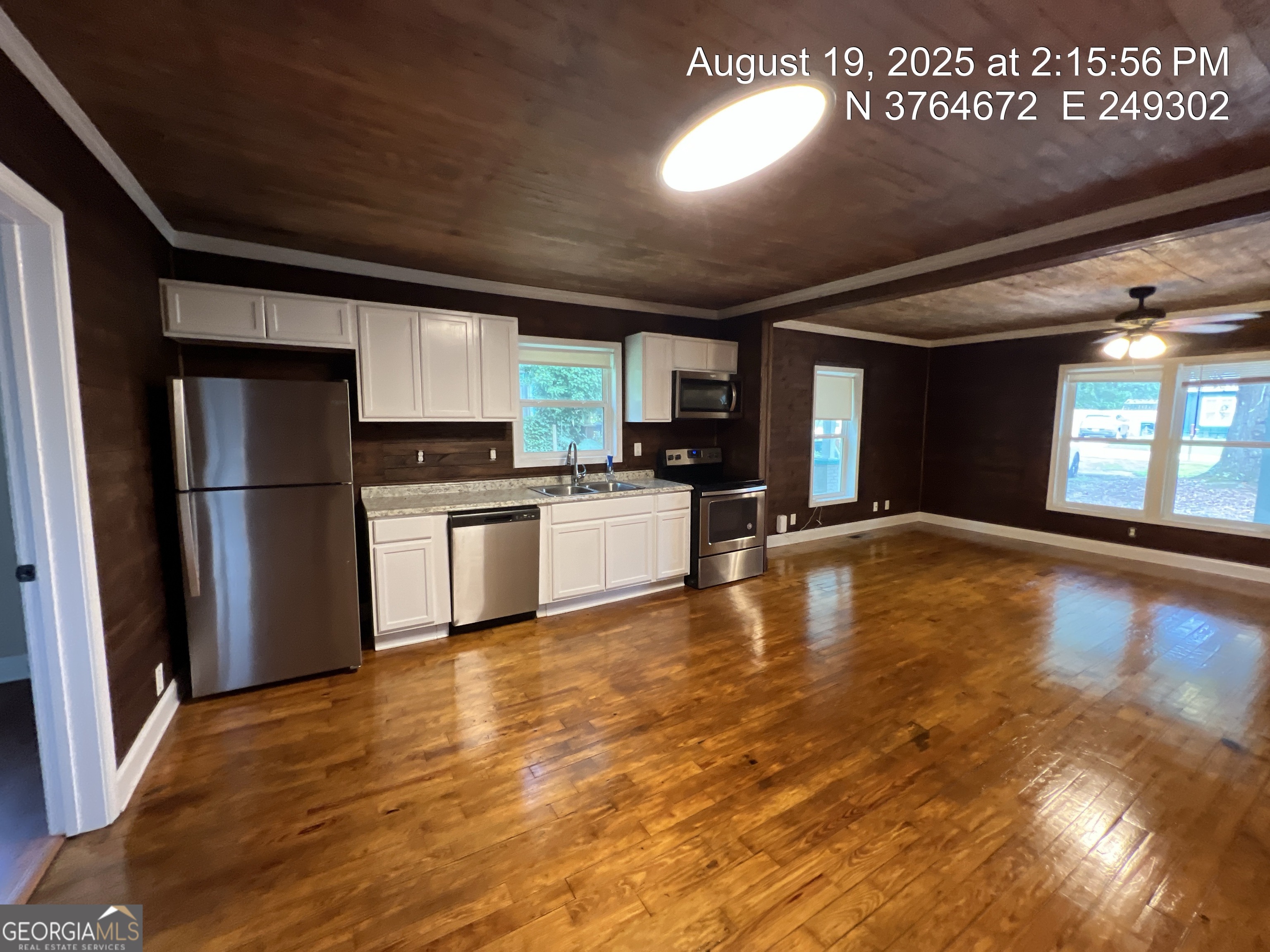 186 Georgia Avenue, Unit B Winder, GA 30680 - Photo 10 of 24 a kitchen with stainless steel appliances granite countertop a refrigerator a stove and a sink with wooden floor