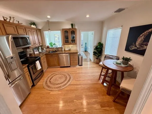 a kitchen with sink refrigerator and microwave