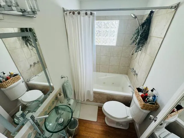a bathroom with a toilet and a shower
