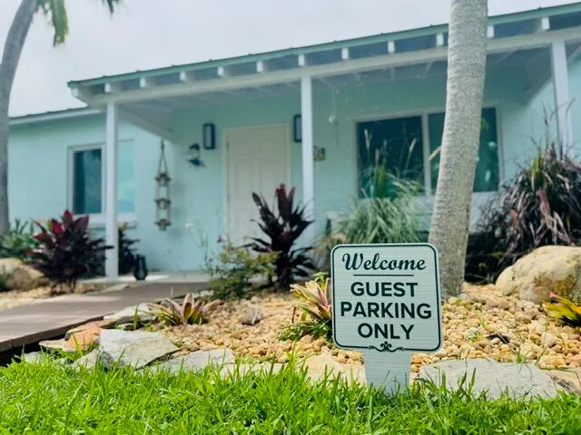 a sign broad in front of flowers