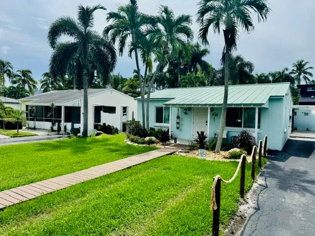a front view of a house with a yard table and chairs