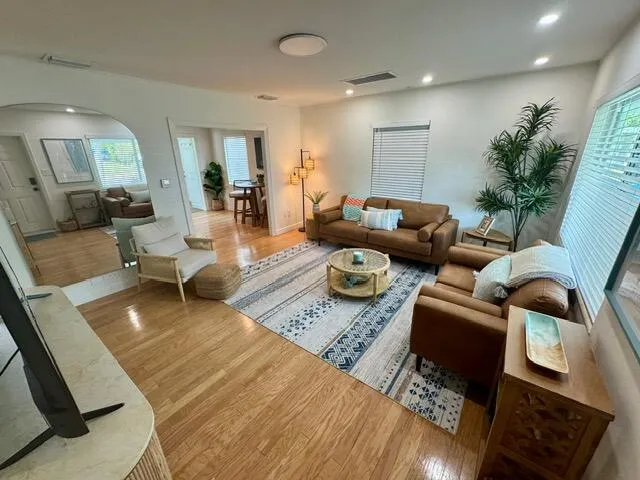 a living room with furniture and wooden floor