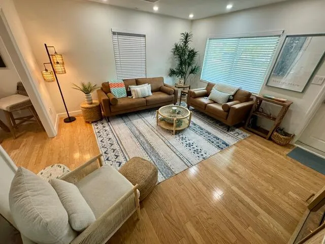 a living room with furniture rug and wooden floor