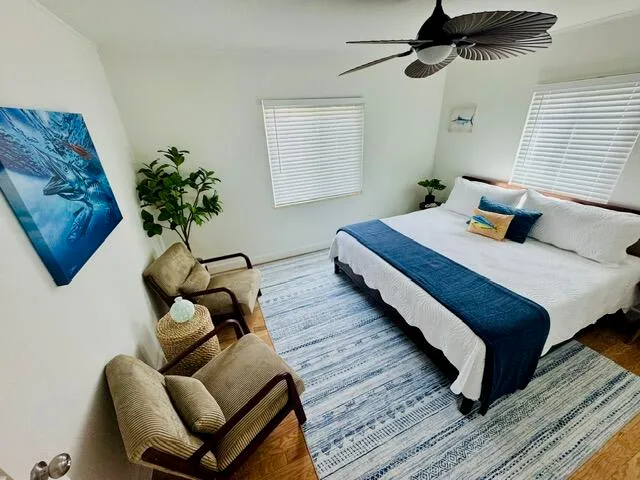 a bedroom with bed and wooden floor