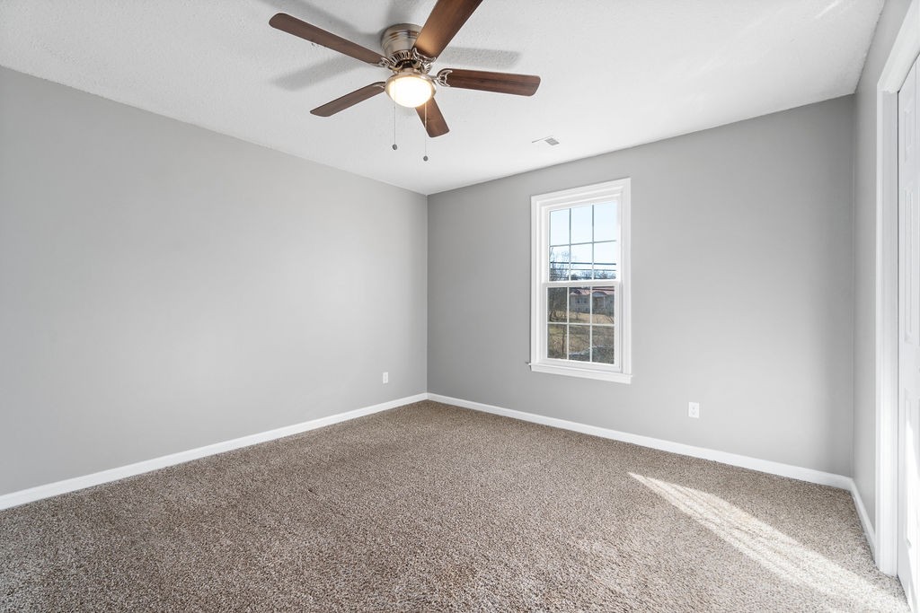 1909 Needmore Road Clarksville, TN 37042 - Photo 12 of 24 an empty room with a window and a fan