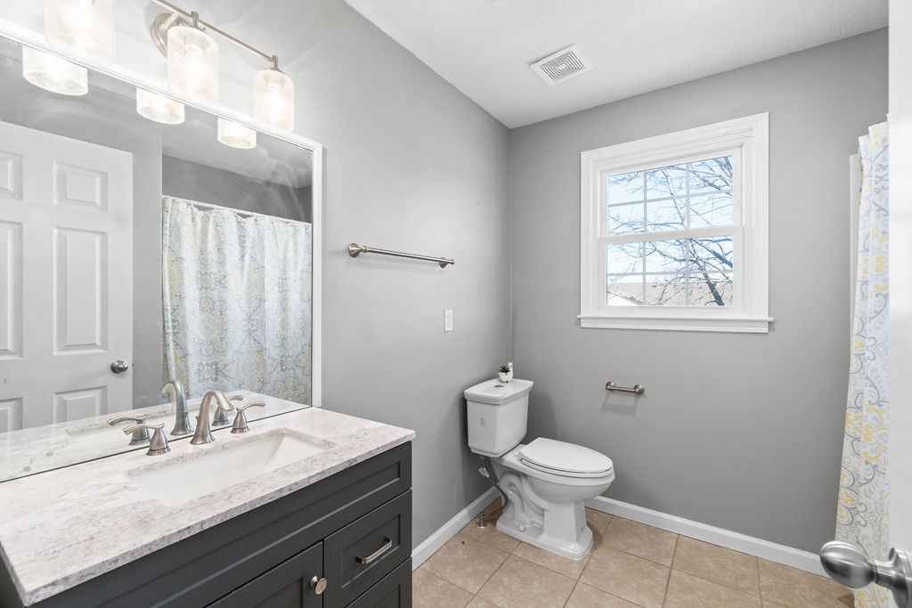 1909 Needmore Road Clarksville, TN 37042 - Photo 14 of 24 a bathroom with a granite countertop sink a toilet and a mirror