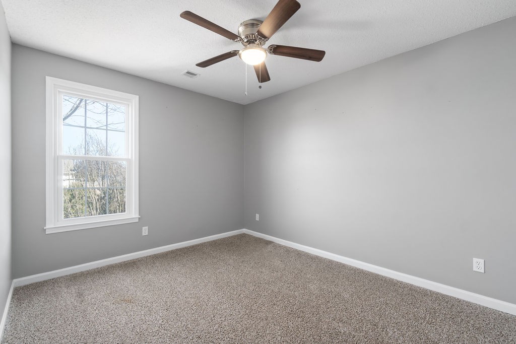 1909 Needmore Road Clarksville, TN 37042 - Photo 15 of 24 an empty room with a window and a fan
