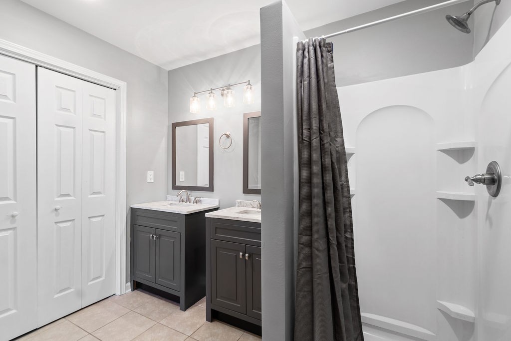 1909 Needmore Road Clarksville, TN 37042 - Photo 16 of 24 a bathroom with a double vanity sink a toilet and a mirror