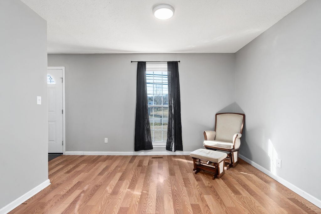 1909 Needmore Road Clarksville, TN 37042 - Photo 7 of 24 a view of a bedroom with a bed and wooden floor