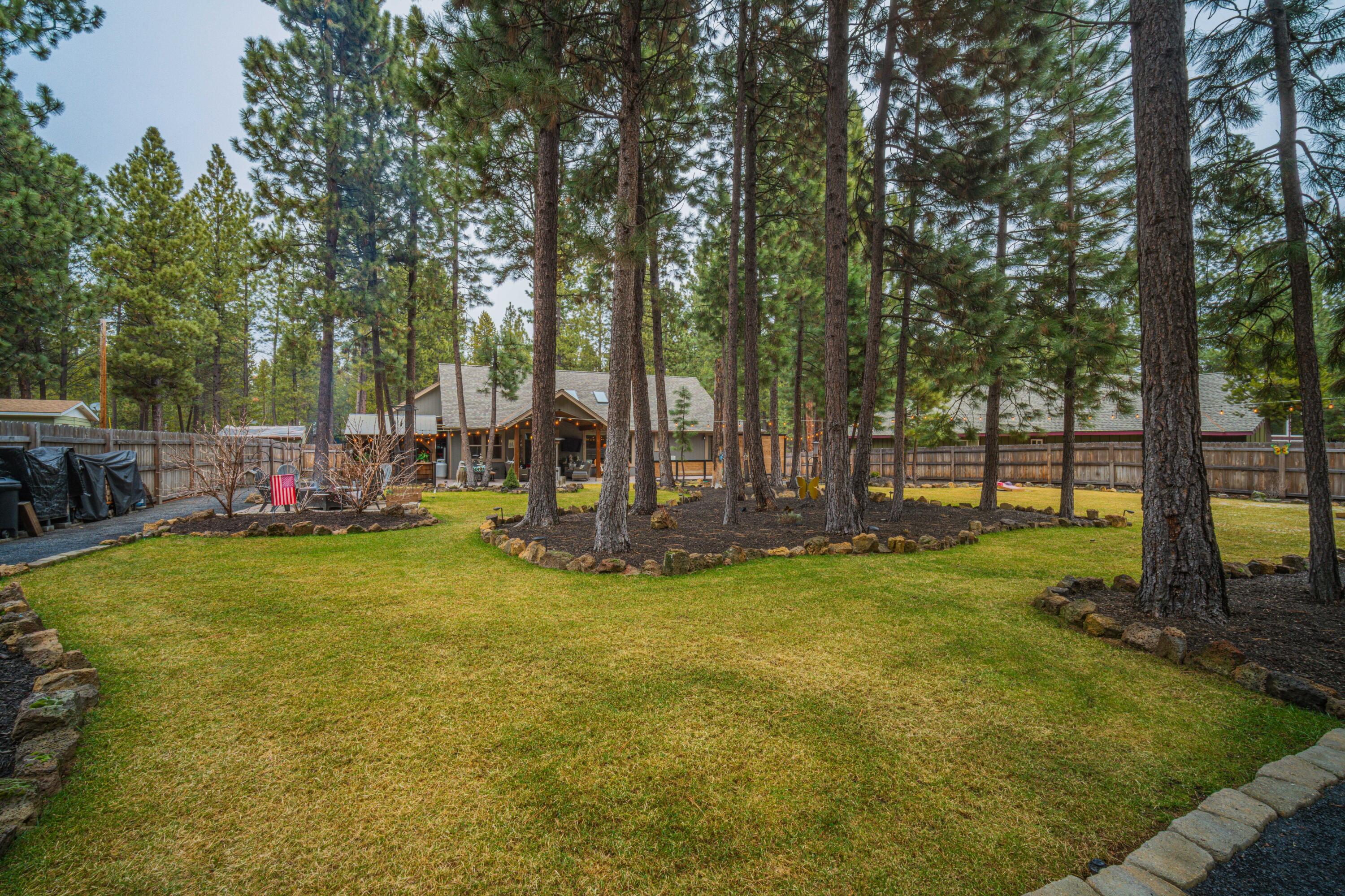 16927 Covina Road Bend, OR 97707 - Photo 40 of 54 Broad backyard lawn view showing the rare depth, mature trees, and park-like setting that distinguish this extraordinary outdoor environment.