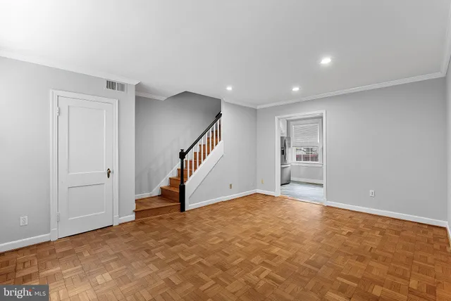 a view of an empty room with stairs
