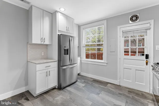 a kitchen with stainless steel appliances granite countertop a refrigerator and a sink