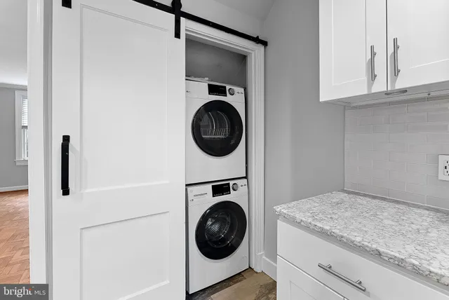 a utility room with sink dryer and washer