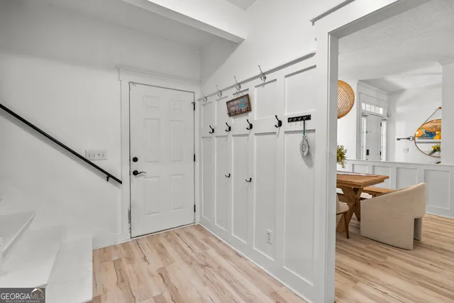 a view of a hardwood floor and staircase in a room