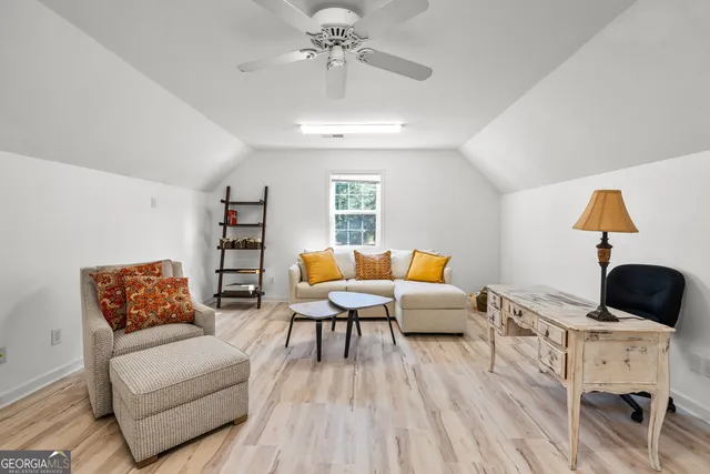 a living room with furniture or couch and a potted plant