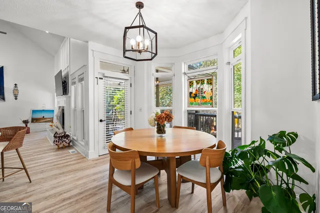 a view of a dining room with furniture wooden floor and chandelier