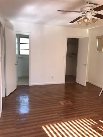 a view of room with window and wooden floor