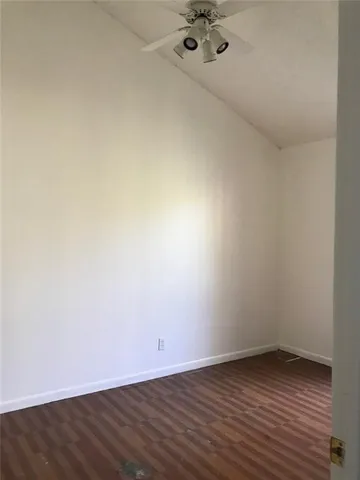 a view of a room with wooden floor