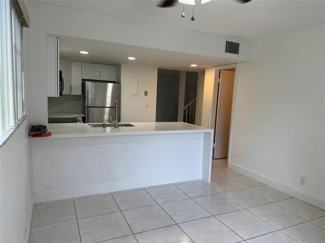 a view of kitchen with granite countertop cabinets